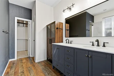 a bathroom with a double vanity sink and mirror