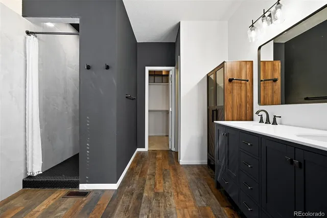 a bathroom with a sink a mirror and a shower