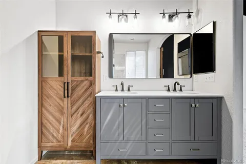 a bathroom with a sink double vanity and mirror