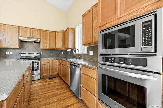 a kitchen with stainless steel appliances a stove a microwave sink and cabinets