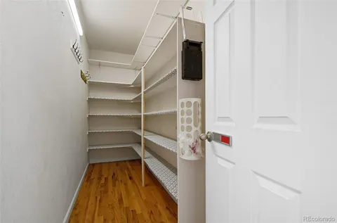 a view of walk in closet with empty racks