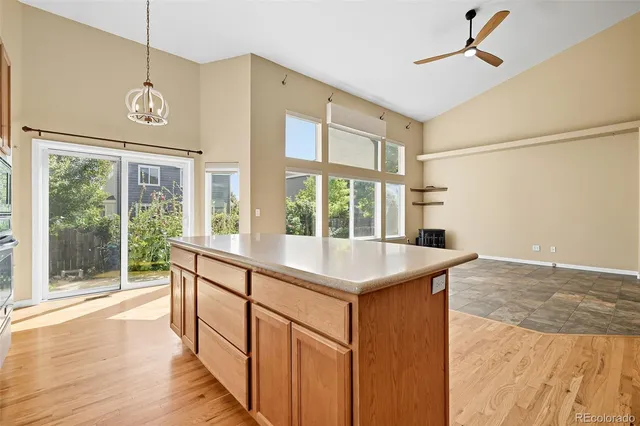 a view of a kitchen with a sink and wooden floor