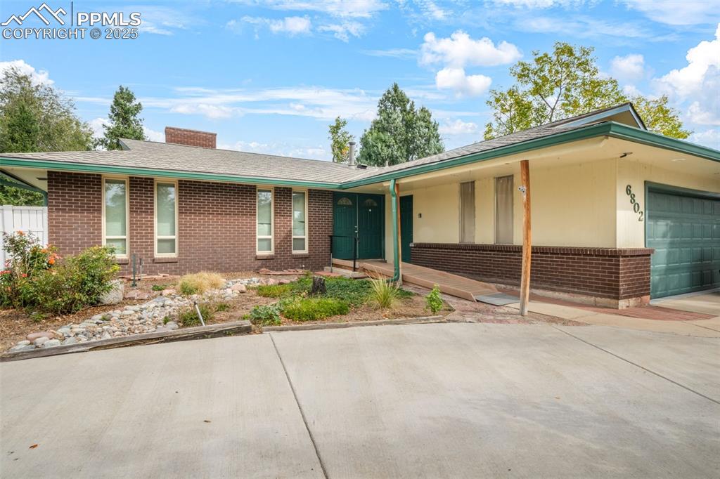 6802 Galley Road Colorado Springs, CO 80915 - Photo 1 of 50 a front view of a house with garden