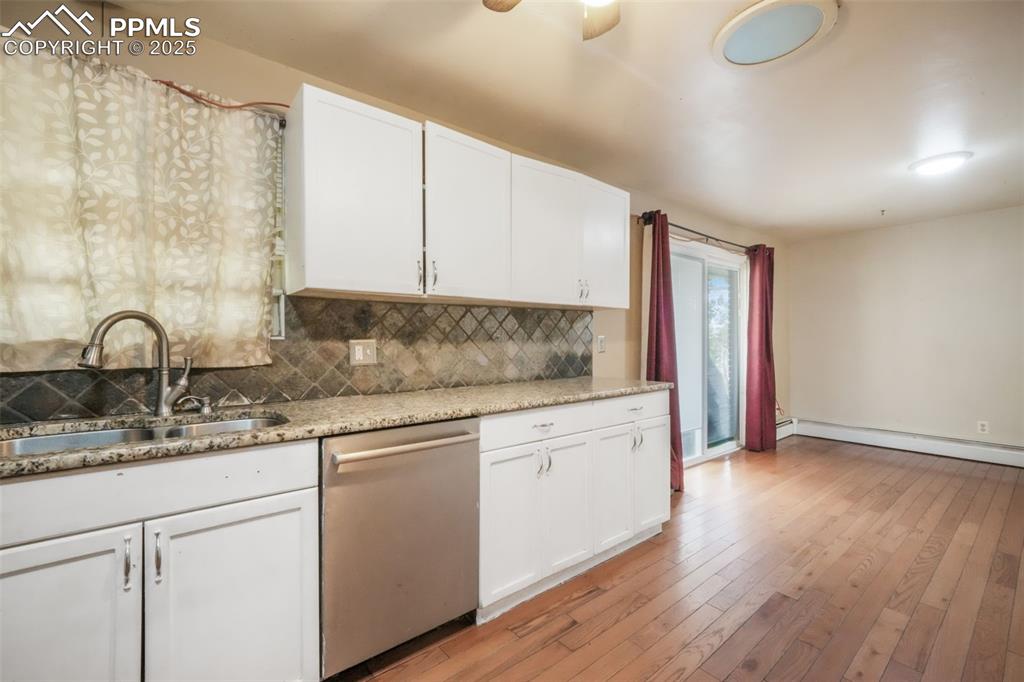6802 Galley Road Colorado Springs, CO 80915 - Photo 11 of 50 a kitchen with granite countertop white cabinets and sink