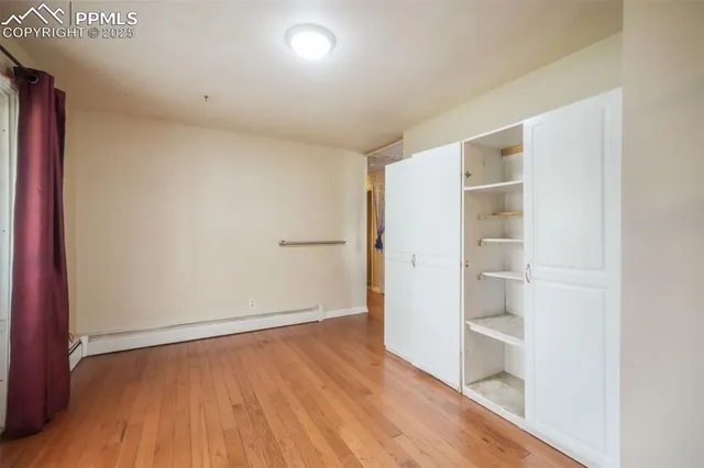 an empty room with wooden floor