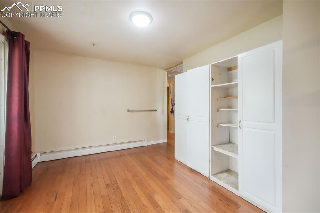 6802 Galley Road Colorado Springs, CO 80915 - Photo 13 of 50 an empty room with wooden floor