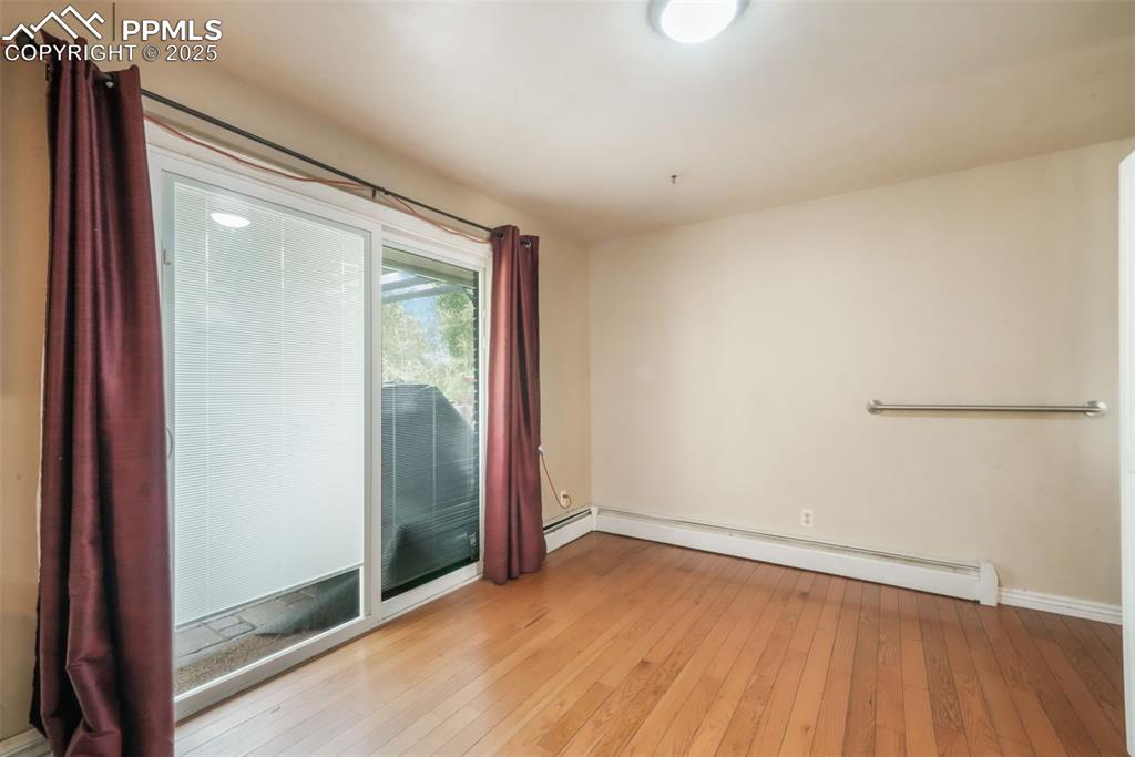 6802 Galley Road Colorado Springs, CO 80915 - Photo 14 of 50 an empty room with wooden floor and door