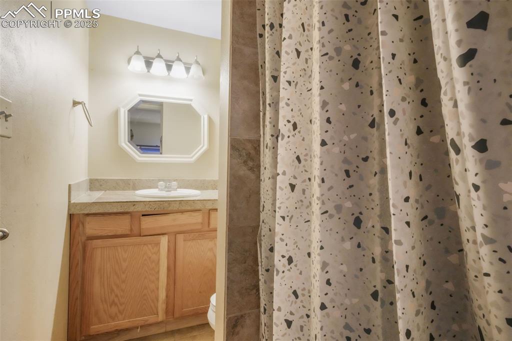 6802 Galley Road Colorado Springs, CO 80915 - Photo 18 of 50 a bathroom with a sink and a mirror