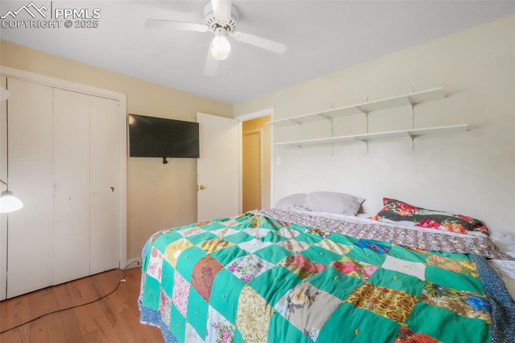 6802 Galley Road Colorado Springs, CO 80915 - Photo 22 of 50 a bedroom with a bed and a flat screen tv