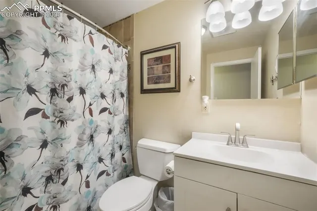 a bathroom with a sink and mirror with toilet