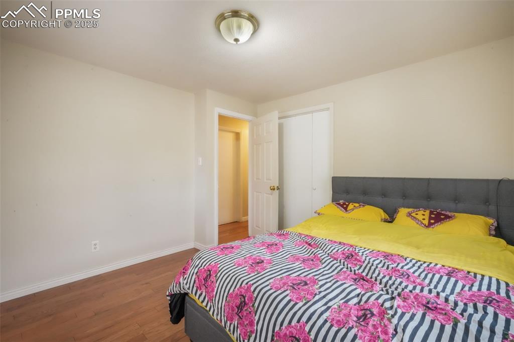 6802 Galley Road Colorado Springs, CO 80915 - Photo 24 of 50 a bedroom with a bed and a window