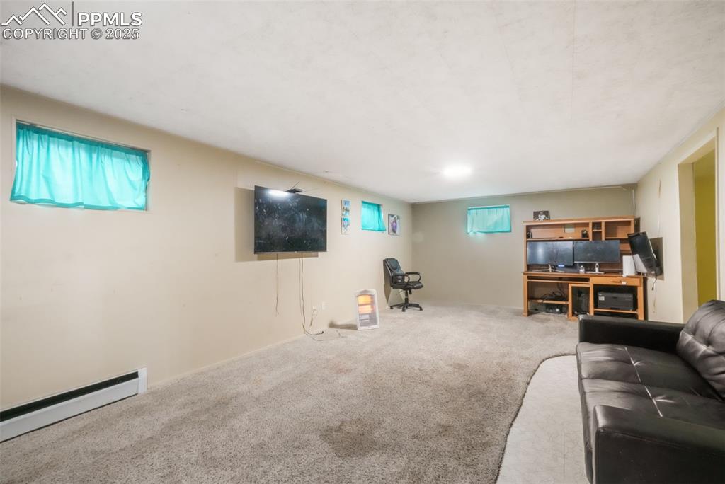 6802 Galley Road Colorado Springs, CO 80915 - Photo 27 of 50 a living room with furniture and a flat screen tv