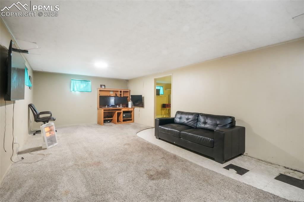 6802 Galley Road Colorado Springs, CO 80915 - Photo 28 of 50 a living room with furniture and a flat screen tv