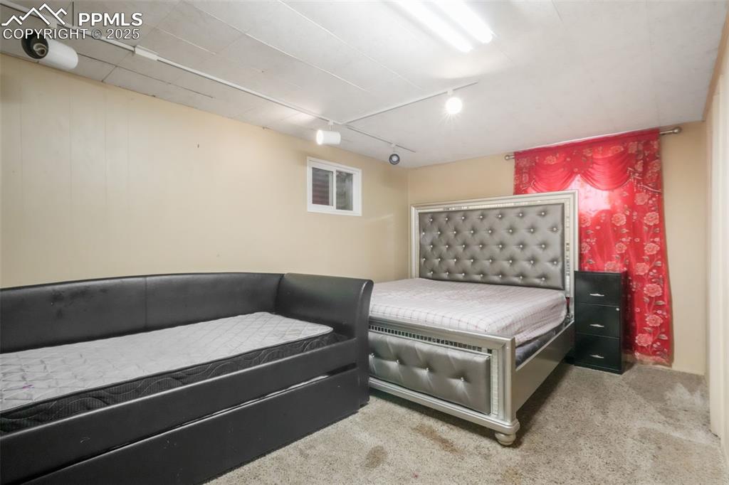 6802 Galley Road Colorado Springs, CO 80915 - Photo 36 of 50 a bedroom with furniture and a dresser
