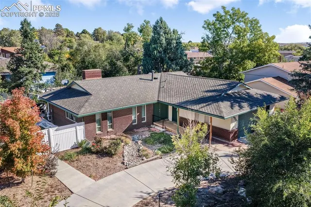 an aerial view of a house with a yard and fountain