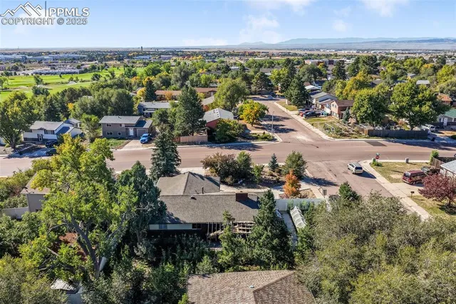 an aerial view of residential house with an outdoor space and seating
