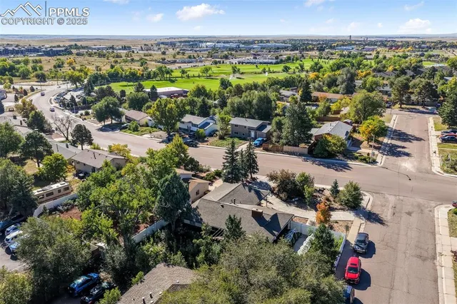 an aerial view of residential houses with outdoor space