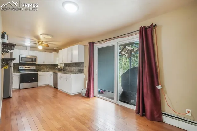 a kitchen with stainless steel appliances granite countertop a refrigerator and a stove top oven