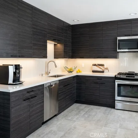 a kitchen with stainless steel appliances wooden cabinets and a sink
