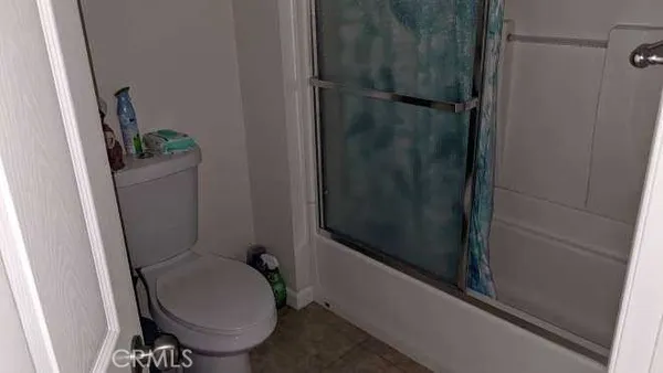 a bedroom with a bed and a mirror