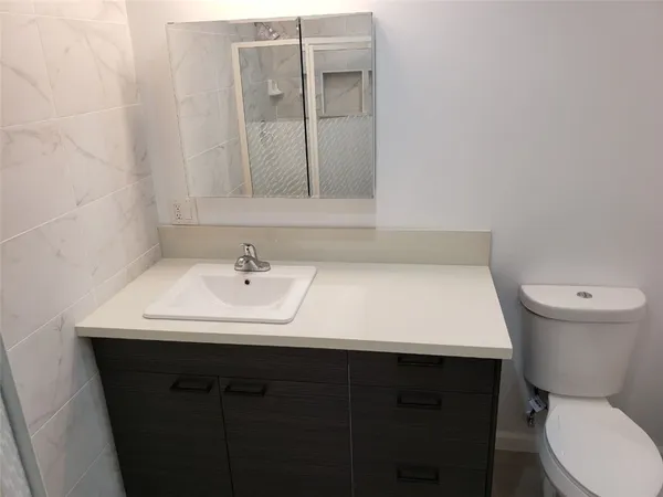 a bathroom with a shower a sink and mirror