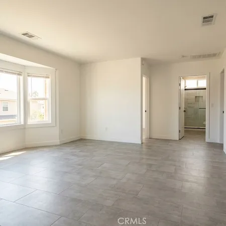 an empty room with windows and closet
