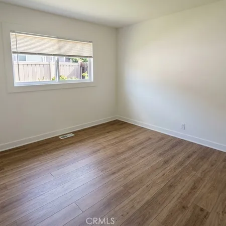 a view of a room with wooden floor and windows