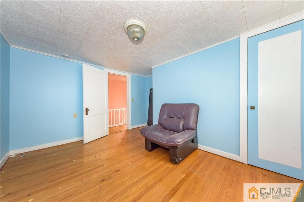86 Main Street Matawan, NJ 07747 - Photo 15 of 25 a living room with furniture and a wooden floor