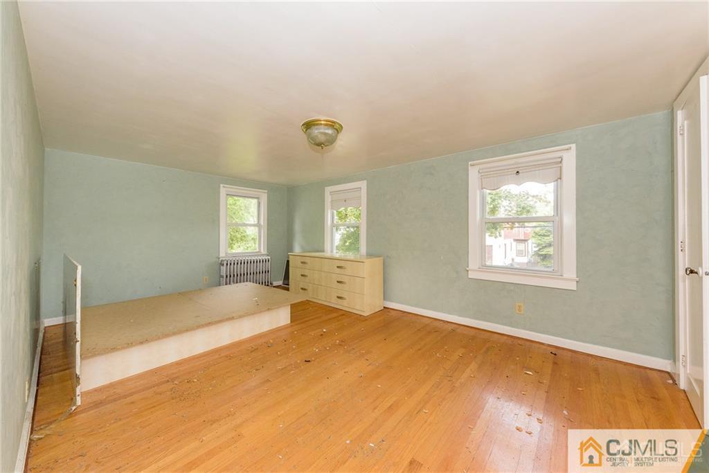 86 Main Street Matawan, NJ 07747 - Photo 17 of 25 a bedroom with a bed and window