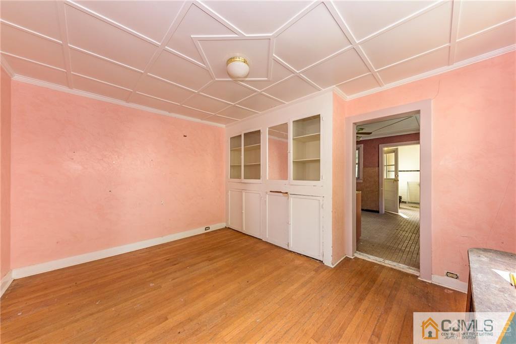86 Main Street Matawan, NJ 07747 - Photo 6 of 25 an empty room with wooden floor and windows