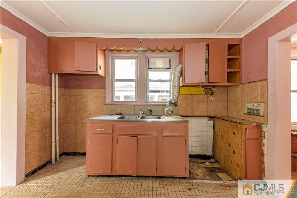 86 Main Street Matawan, NJ 07747 - Photo 9 of 25 a utility room with a stove a washer and dryer