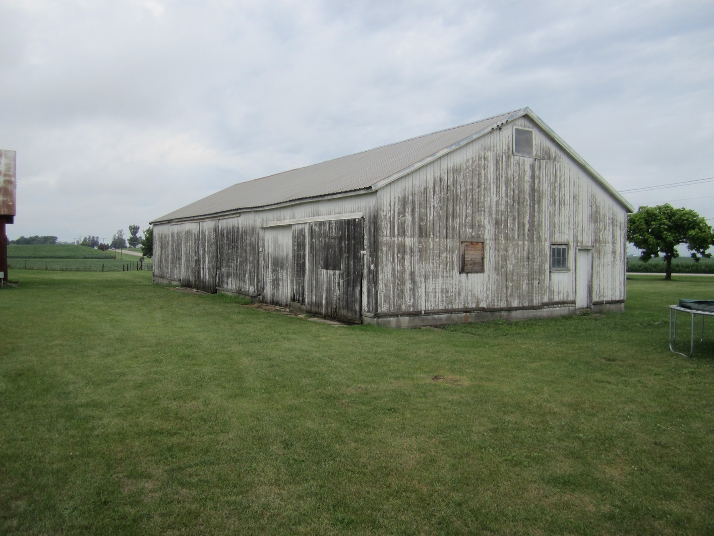5668 And 5708 State Route Malta, IL 60150 - Photo 3 of 37 a backyard of a house with lots of green space and wooden fence