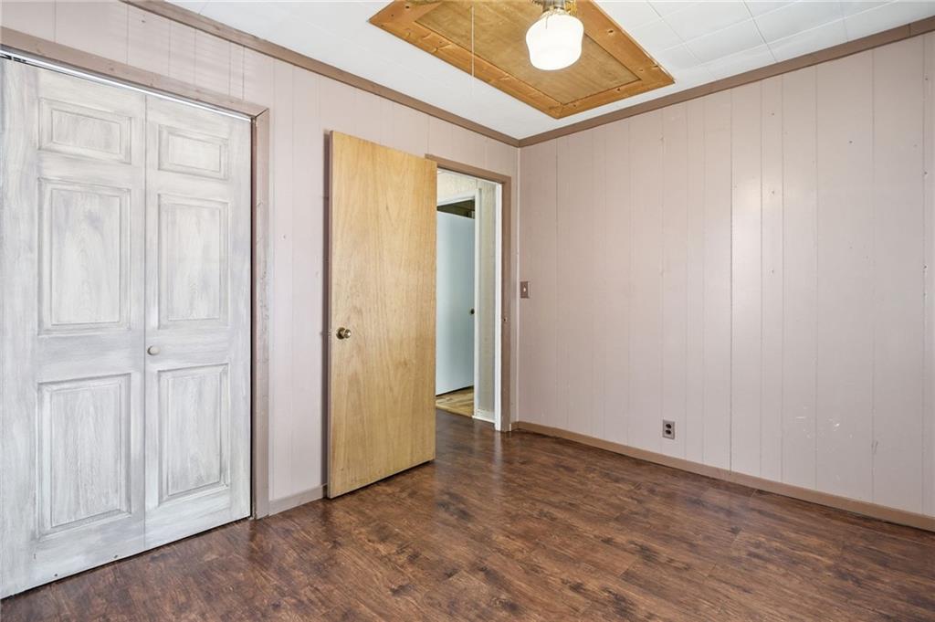 1709 Harrington Road Ball Ground, GA 30107 - Photo 21 of 46 an empty room with wooden floor and closet