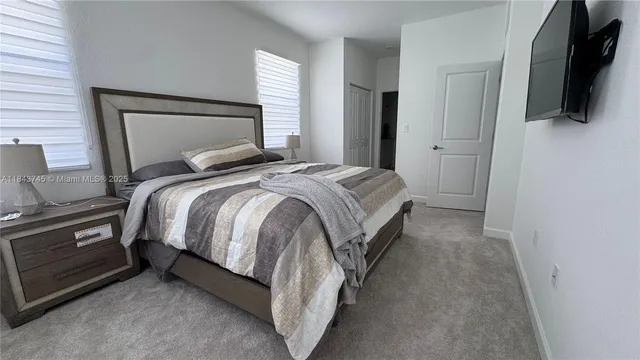 a bedroom with a bed and flat screen tv