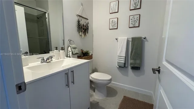 a bathroom with a sink toilet and mirror