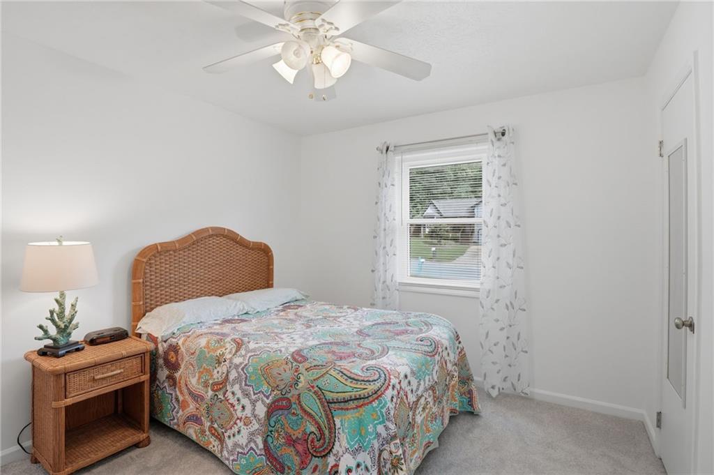 338 Arbour Way Suwanee, GA 30024 - Photo 11 of 32 a bedroom with a bed and a chandelier