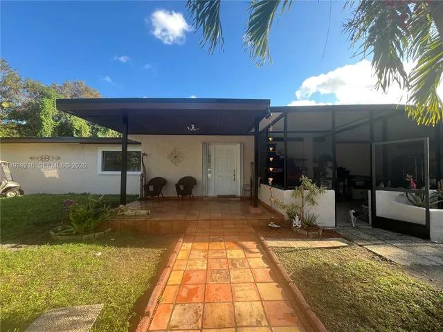 a view of a backyard with plants and a patio
