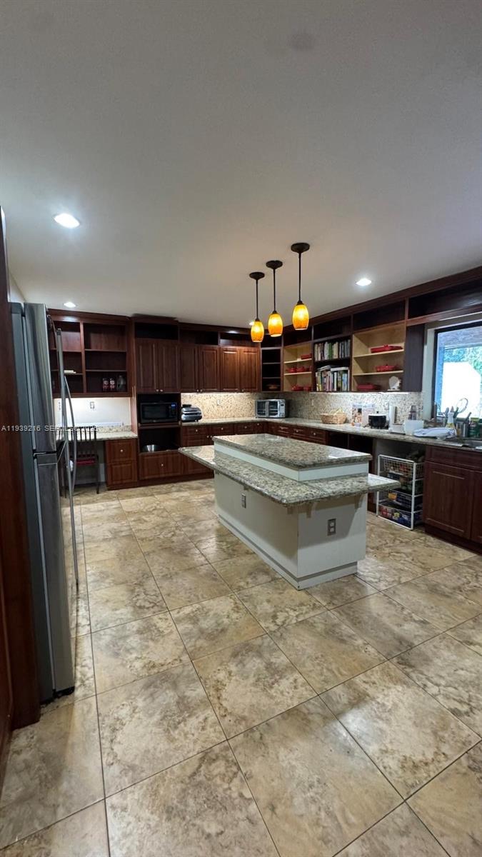 17540 Southwest 254th Street Homestead, FL 33031 - Photo 41 of 85 a kitchen with stainless steel appliances granite countertop a stove refrigerator and cabinets