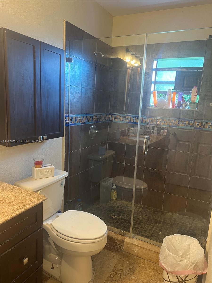 17540 Southwest 254th Street Homestead, FL 33031 - Photo 68 of 85 a bathroom with a toilet a sink and shower