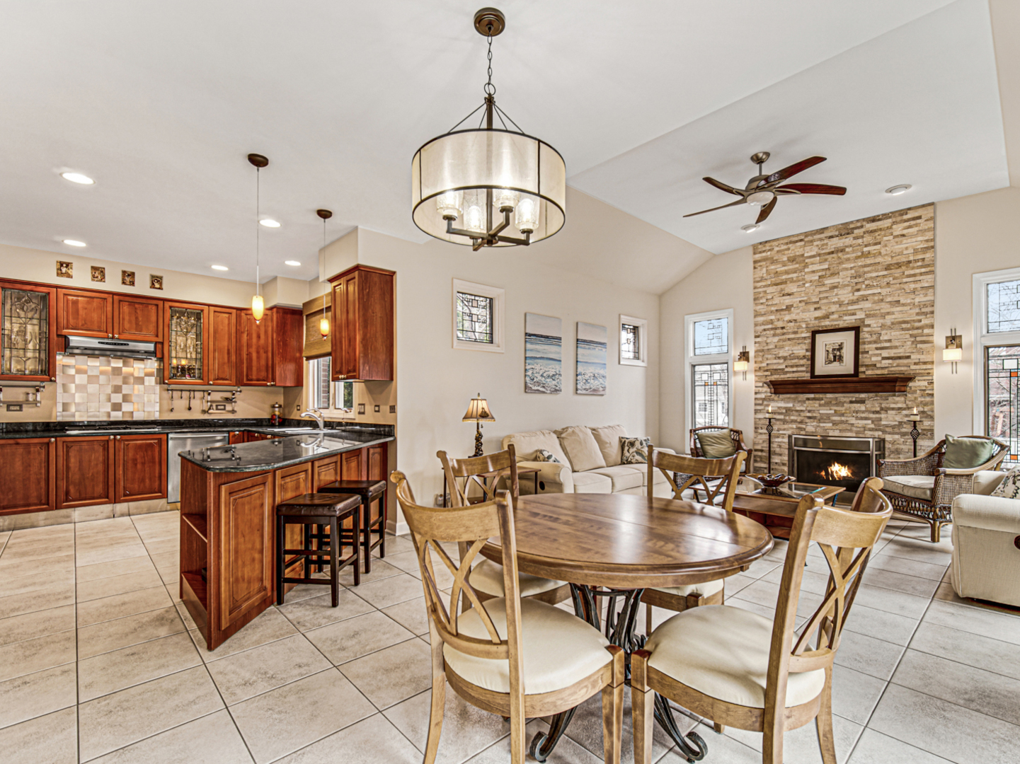 631 Riverside Drive Park Ridge, IL 60068 - Photo 7 of 31 a kitchen with stainless steel appliances granite countertop a stove a sink a dining table and chairs