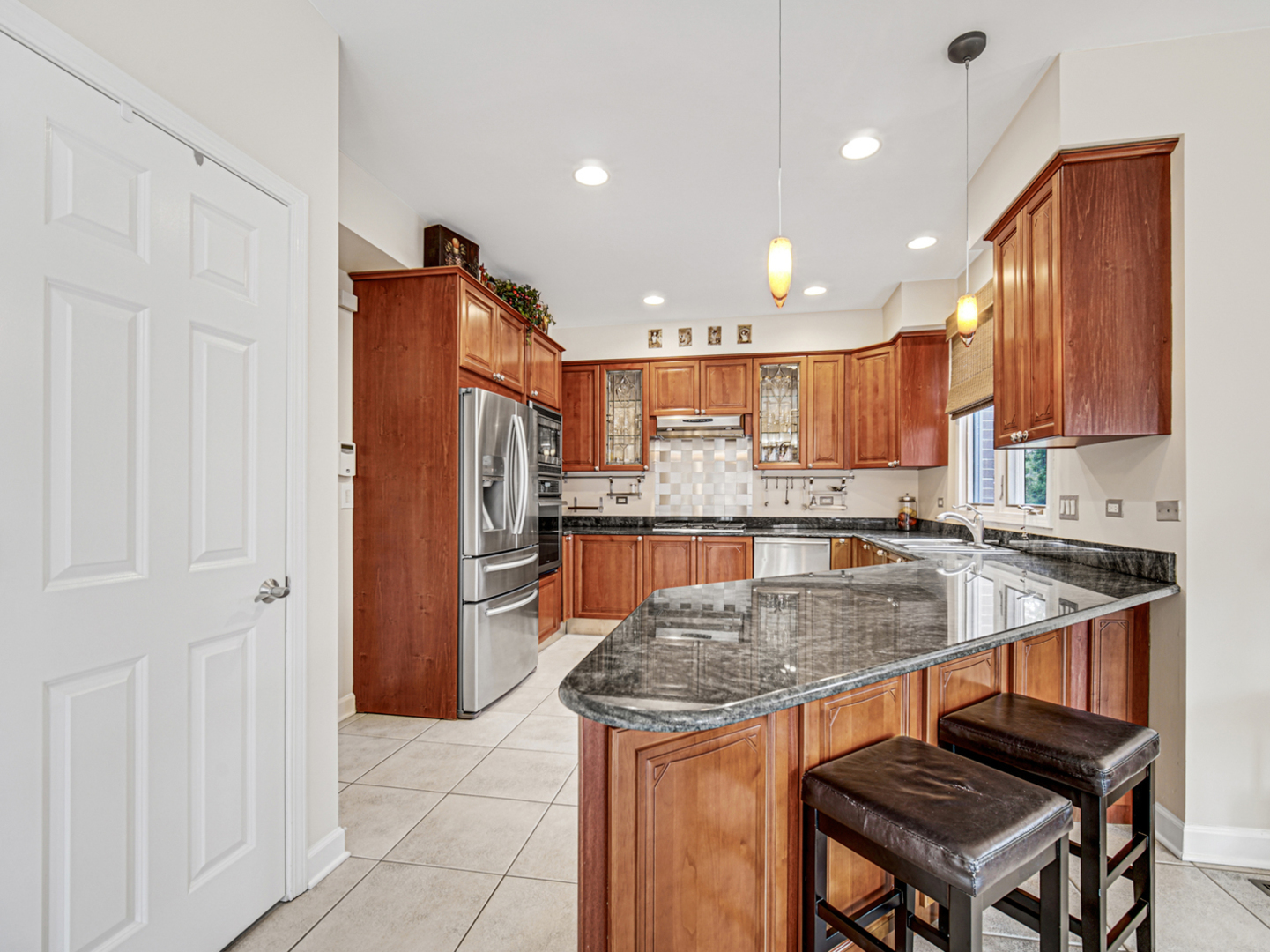 631 Riverside Drive Park Ridge, IL 60068 - Photo 9 of 31 a kitchen with stainless steel appliances granite countertop a stove a sink a refrigerator and chairs