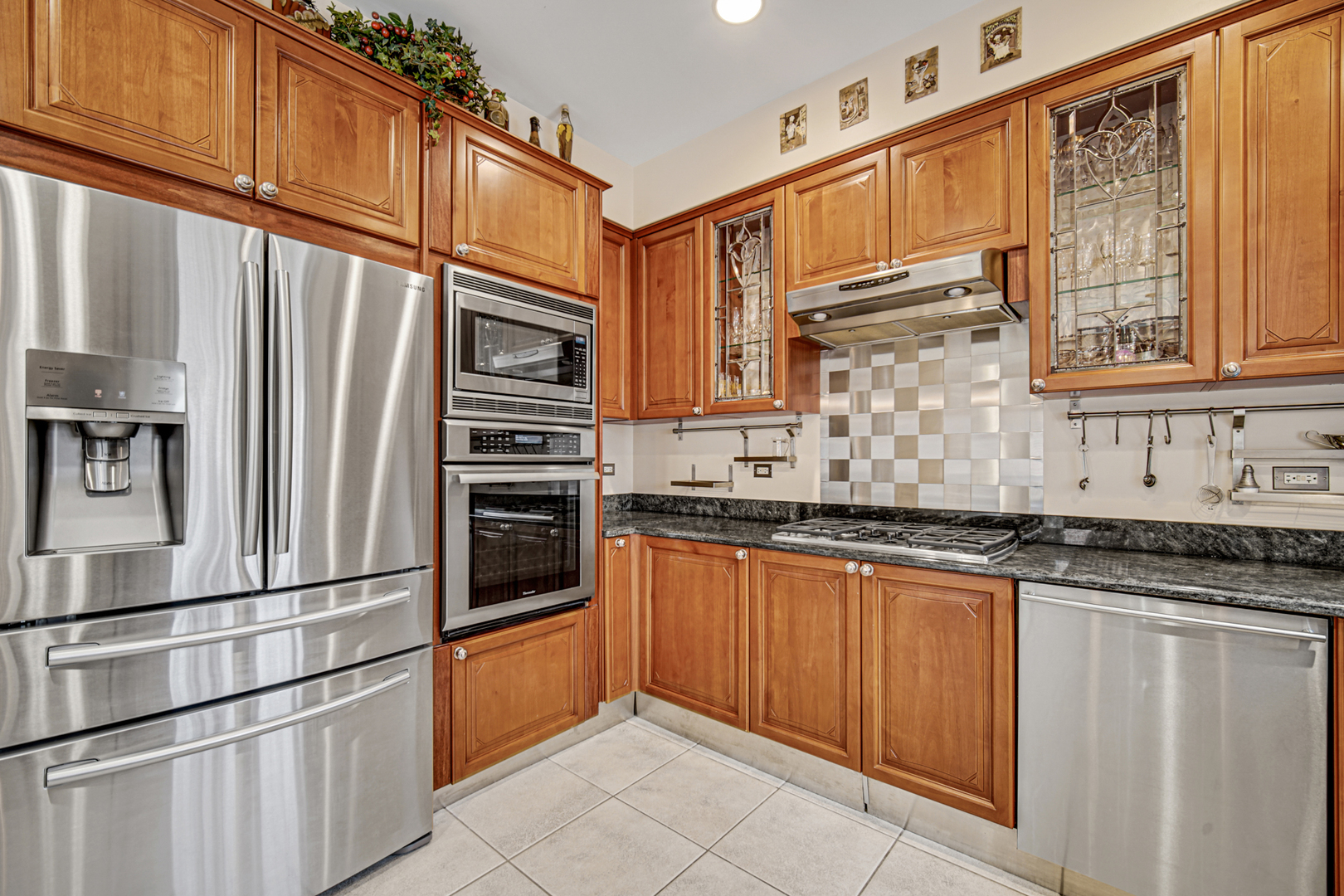 631 Riverside Drive Park Ridge, IL 60068 - Photo 10 of 31 a kitchen with stainless steel appliances granite countertop a refrigerator a stove and a sink