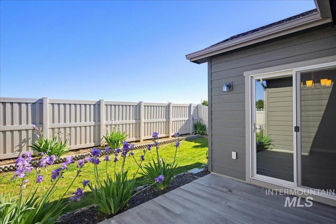 12460 West Azure Street Boise, ID 83713 - Photo 31 of 34 Rear patio with wood-finish flooring, sliding glass doors, and horizontal siding