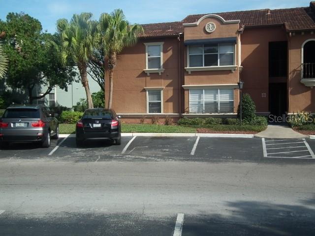 5128 Conroy Road, Unit 715 Orlando, FL 32811 - Photo 1 of 1 a front view of a house with a yard