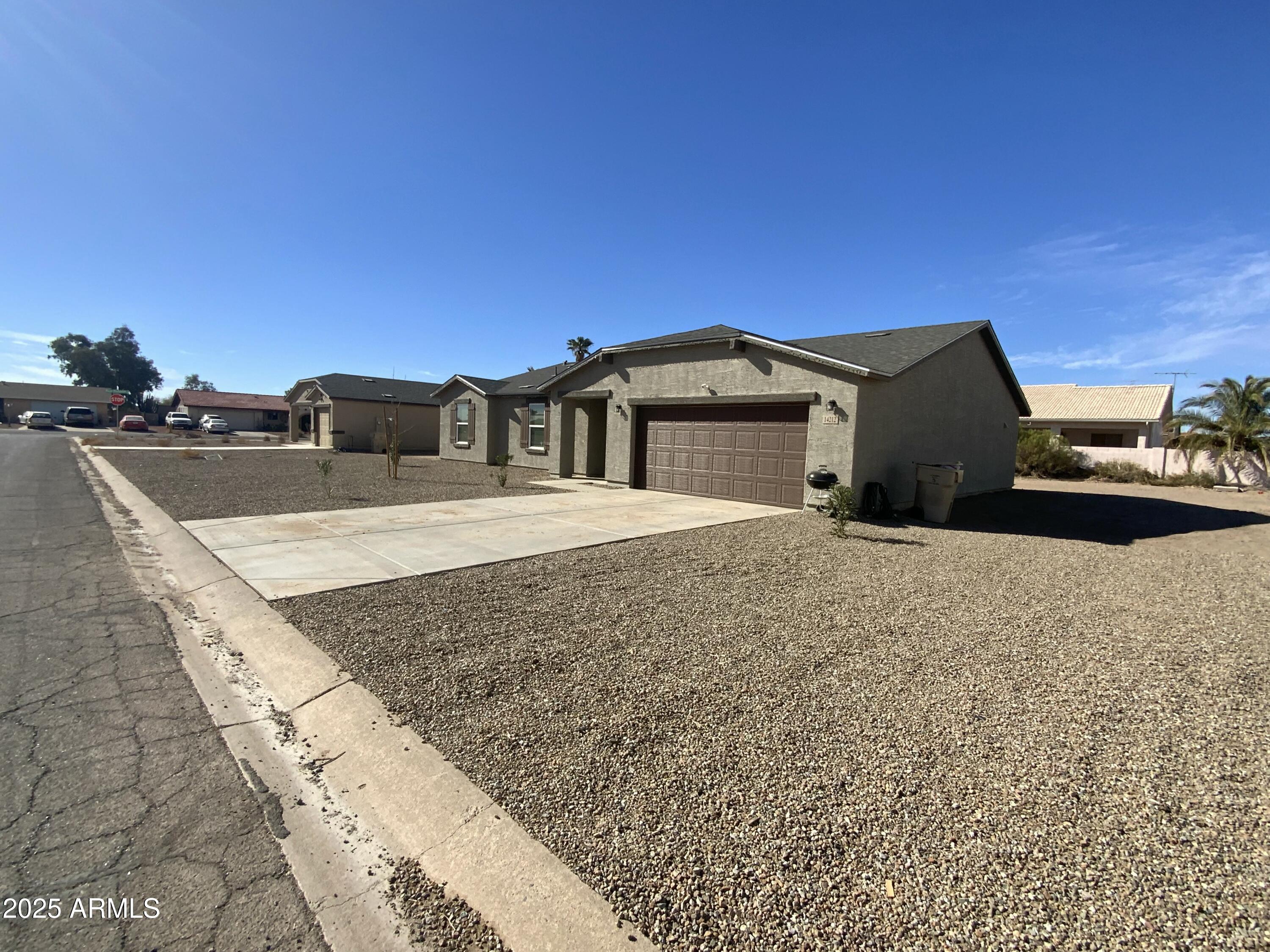 14154 South Berwick Road, Unit 2270 Arizona City, AZ 85123 - Photo 7 of 7 a front view of a house with trees