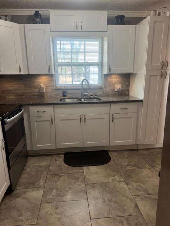 45 Plainview Street Rockmart, GA 30153 - Photo 5 of 24 a kitchen with granite countertop a sink window and cabinets