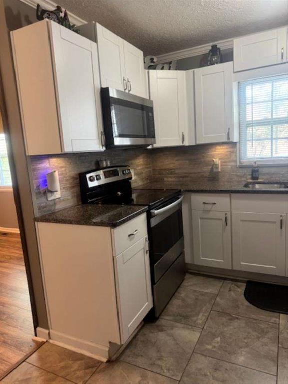 45 Plainview Street Rockmart, GA 30153 - Photo 6 of 24 a kitchen with stainless steel appliances a sink cabinets and a window