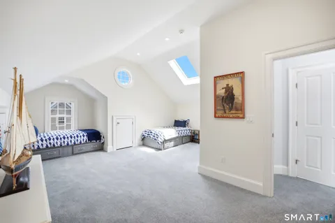 a spacious bedroom with a bed and a couch