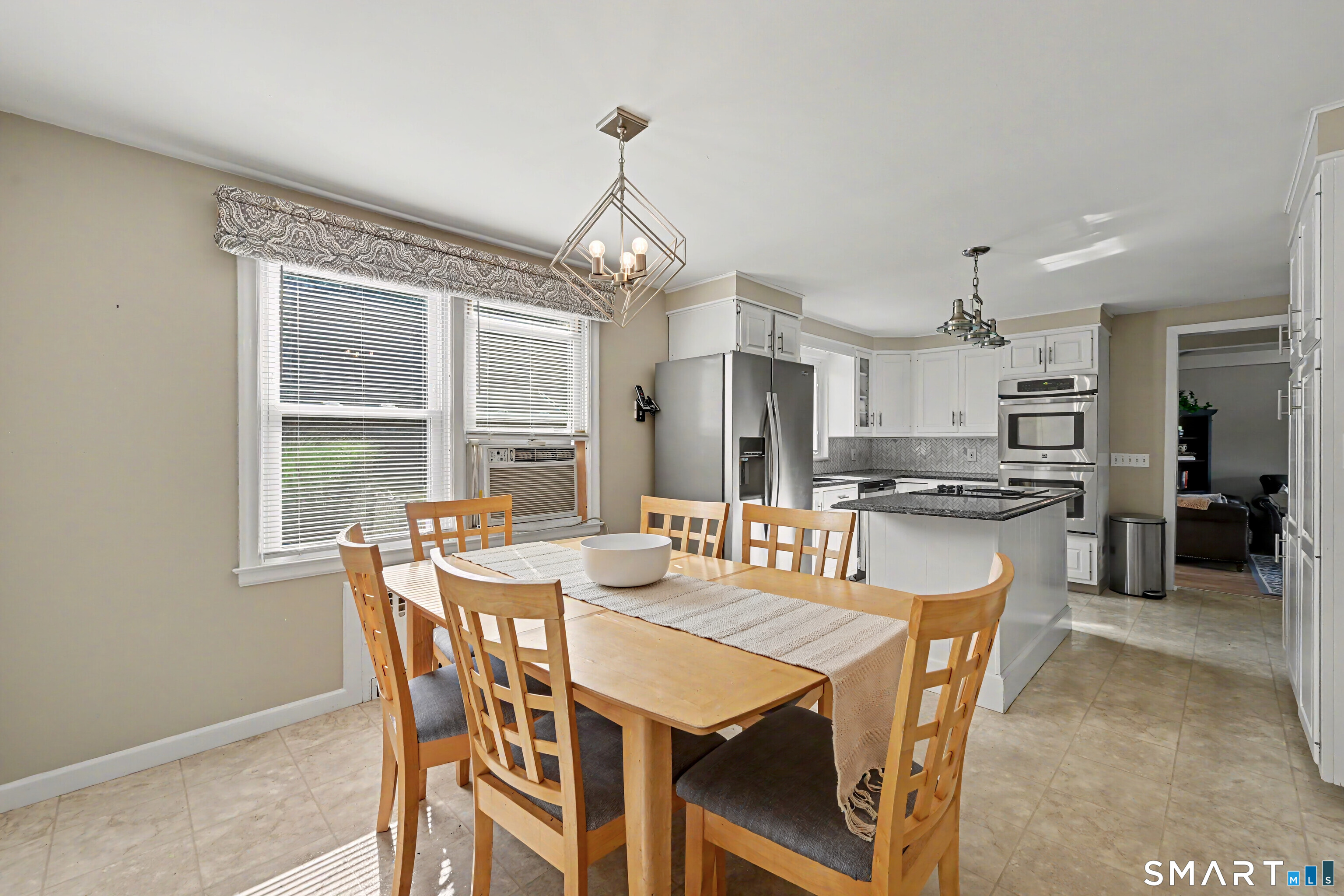 524 Ferry Road Orange, CT 06477 - Photo 9 of 40 a dining room with furniture a chandelier and wooden floor