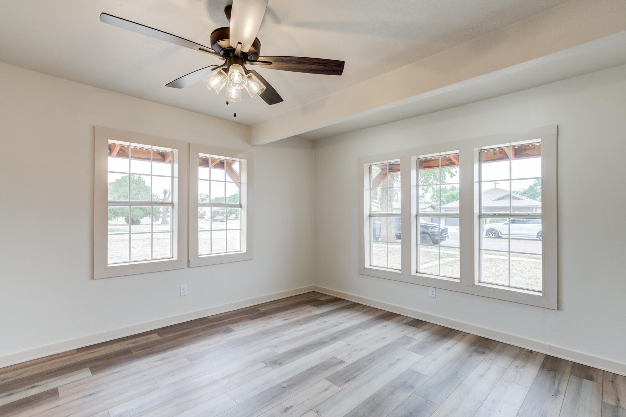315 West Garza Street Slaton, TX 79364 - Photo 12 of 35 a view of an empty room with window and wooden floor